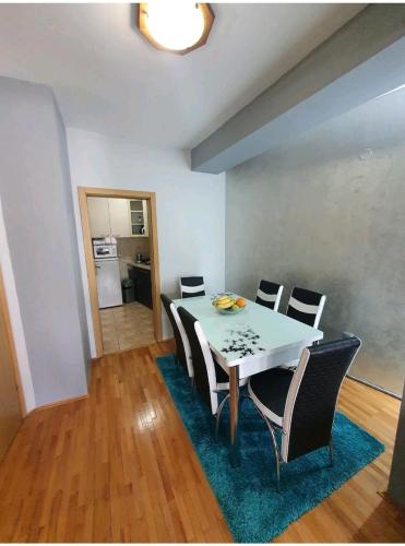 a dining room with a white table and chairs at Apartman Nikolaj - Lovely 3 room apartment in the center of Ohrid in Ohrid