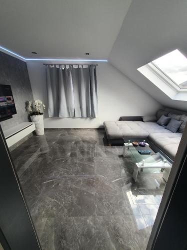 a living room with a couch and a table at New York City Apartment in Paderborn