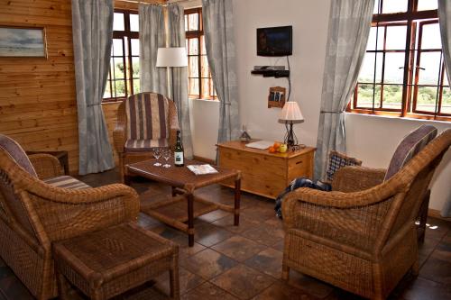 a living room with chairs and a table at Stone Hill in Magaliesburg