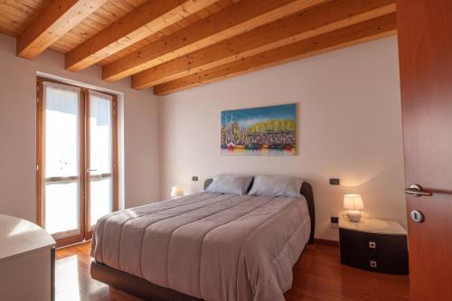 a bedroom with a bed and a large window at Happy Guest Apartments - Lake & Relax in Riva di Solto