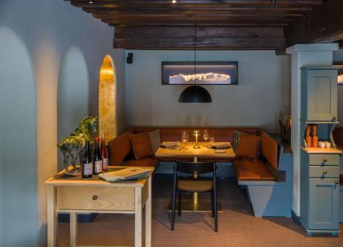 a dining room with a table and a couch at Eibsee Hotel in Grainau