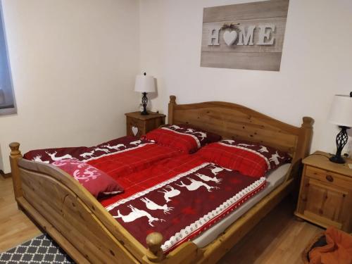a bedroom with a bed with a red comforter at Ferienwohnung GABI in Forbach
