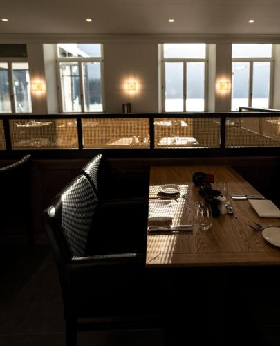 a table in a restaurant with a wooden table sidx sidx sidx at Eibsee Hotel in Grainau