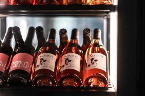a group of bottles of wine in a refrigerator at Eibsee Hotel in Grainau