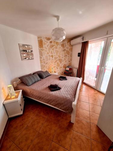 a bedroom with a bed and a stone wall at Apartment Villa Engel with Pool in Poreč