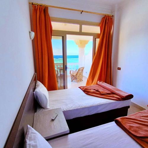 a bedroom with a bed with a view of the ocean at Lucky palace Dahab in Dahab