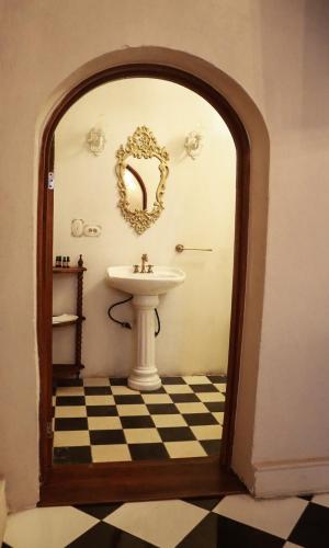 a bathroom with a sink and a mirror at La Casa del General Hotel Boutique in Hidalgo del Parral