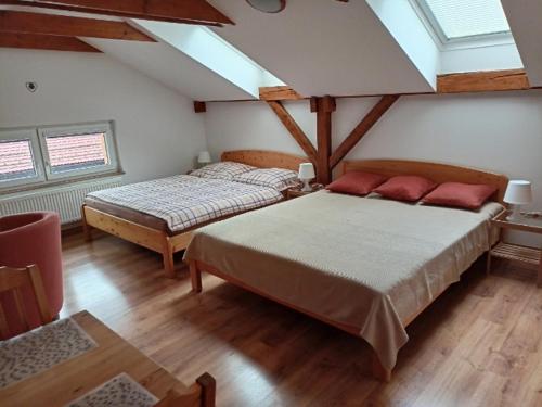 a bedroom with two beds and a ceiling with skylights at Pension Na Vyhlídce in Český Krumlov