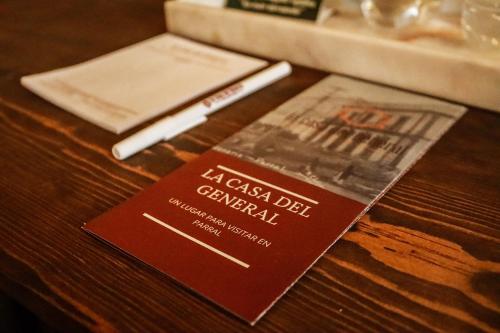 a passport sitting on top of a wooden table at La Casa del General Hotel Boutique in Hidalgo del Parral