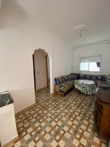 a living room with a couch and a table at Appartement MARTIL BEACH 2 in Martil