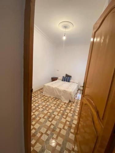 a bedroom with a bed in a room at Appartement MARTIL BEACH 2 in Martil