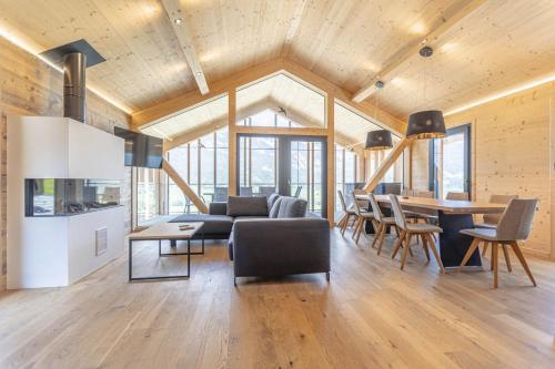 a living room with a couch and a table at Bergresort Hauser Kaibling by ALPS RESORTS in Haus im Ennstal