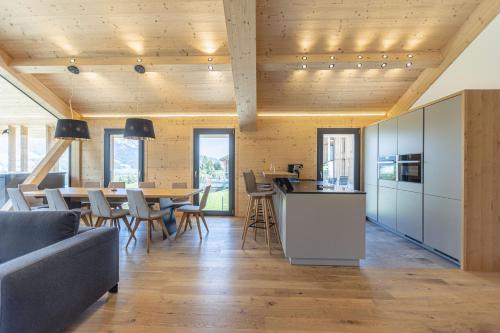 a kitchen and dining room with a table and chairs at Bergresort Hauser Kaibling by ALPS RESORTS in Haus im Ennstal