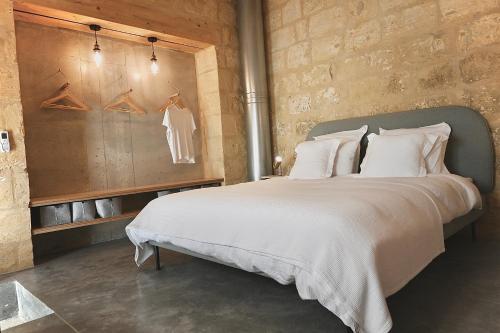 1 dormitorio con 1 cama grande con almohadas blancas en NUMRU 27 Expertly restored small house of character, en Cospicua