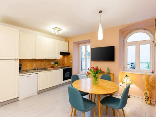 a kitchen and dining room with a table and chairs at Apartment Anika Old Town in Poreč