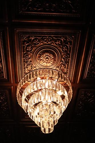a chandelier hanging from a ceiling in a room at La Casa del General Hotel Boutique in Hidalgo del Parral