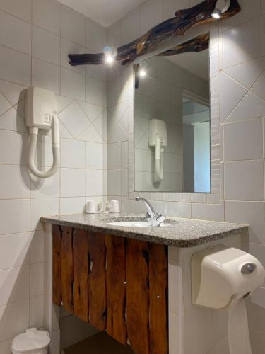a bathroom with a sink and a mirror at Auberge Coralli in Sartène