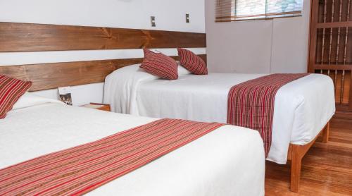 Una cama o camas en una habitación de La Casona Real Cusco