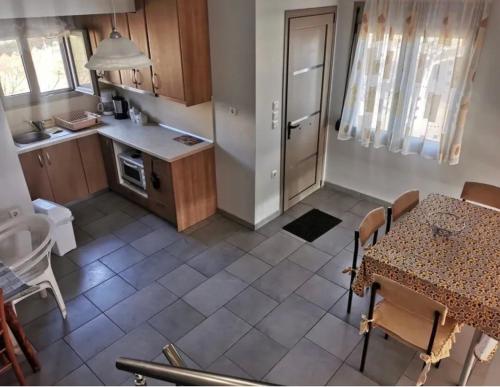 a small kitchen with a table and a table and chairs at Villa TERVEL in Xanthi