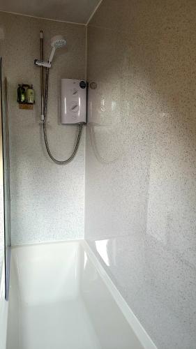 a shower in a bathroom with a tub and a shower at Comfortable flat in Fort William in Fort William