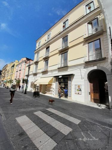 a person walking a dog in front of a building at Casa Sciò in Sorrento