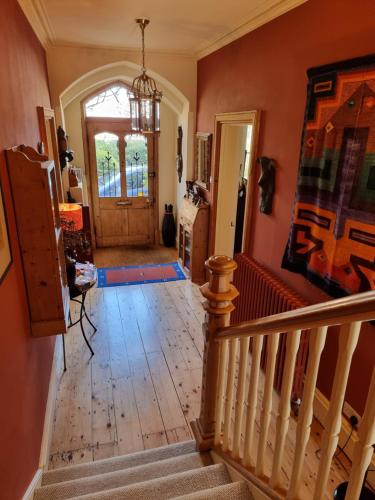 a hallway of a house with a staircase and a door at Alma House Bed and Breakfast in Newbury