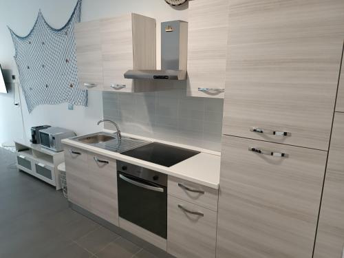 a kitchen with a sink and a stove at savonaamare 2.0 in Savona
