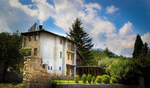 an old stone house with a fence in front of it at Villa Pontica in Sofia