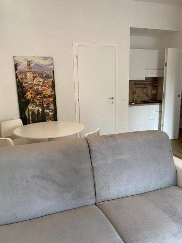 a living room with a couch and a table at UNIQUE ROOMS in Verona