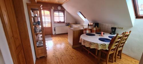 a kitchen with a table and chairs in a room at Patkóház in Keszthely