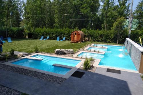 a swimming pool in a backyard with a tent at Chalets et Spa Lac Saint-Jean in Chambord