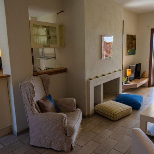 a living room with two chairs and a fireplace at Alemar Estates Ouranoupolis in Ouranoupoli