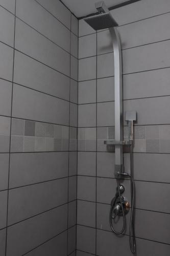 a shower with a shower head in a bathroom at Oriental Nature in Majdal Shams