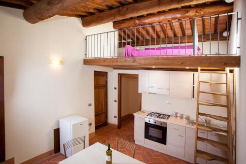 a kitchen with a loft bed in a room at Borgo alle Mura in Casale Marittimo