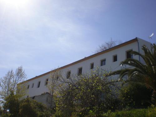 a white building with trees in front of it at Apartamentos Rurales El Cañuelo de Carcabuey in Carcabuey