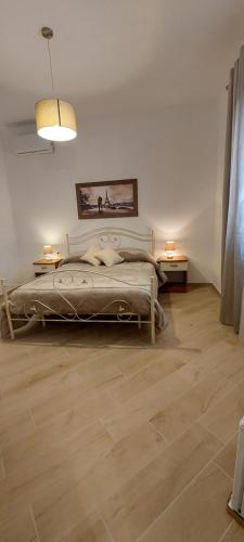 a bedroom with a bed and two end tables at Casa Francesca e Rooms in Santa Maria di Castellabate