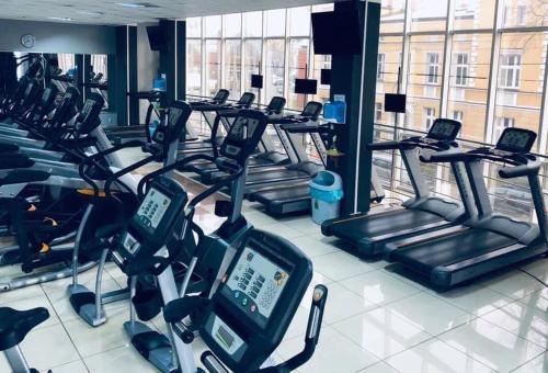 a gym with several rows of cardio machines at Apartament Zamkowy 2 in Kwidzyn