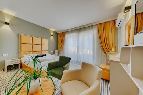 a hotel room with a bed and a chair at AM Palace in Ulcinj