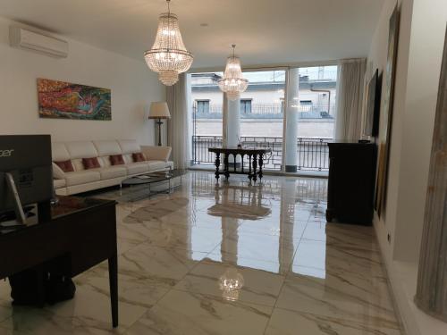 a living room with a couch and a table at Royal Boutique Napoli in Naples