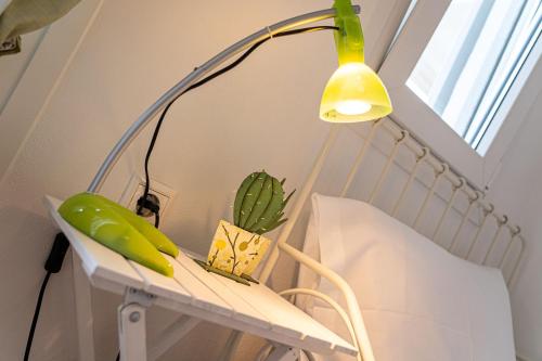 a lamp on a table with a banana and a plant at Alemar Estates Agia Triada in Agia Triada