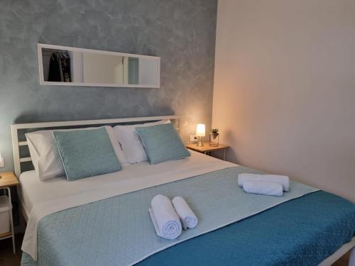 a bedroom with a large bed with towels on it at Apartment Maris Nin in Nin