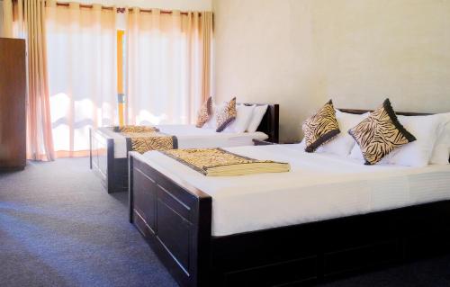 a room with three beds in a room at W1 Ella in Ella