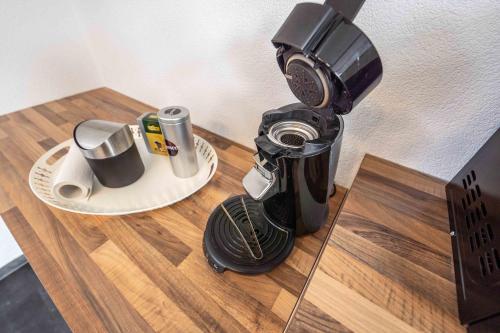 a coffee maker sitting on top of a wooden table at City Wohnung FN L 5 KLIMATISIERT mit Balkon und Küche in Friedrichshafen