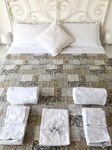 a bed with towels on the floor next to it at B&B Il Poeta sul Mare in Ancona