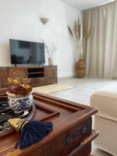 a living room with a tv and a coffee table at Villa Neptunus in Ischia