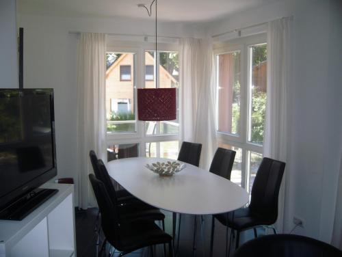 a dining room with a table and chairs and a window at Ferienwohnung Baabe in Baabe