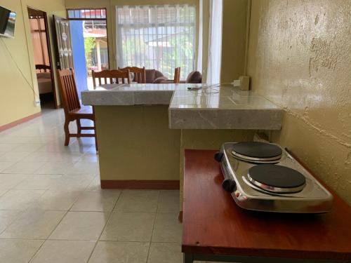 a kitchen with a counter with a stove top on a table at Blue House in Puerto Jiménez