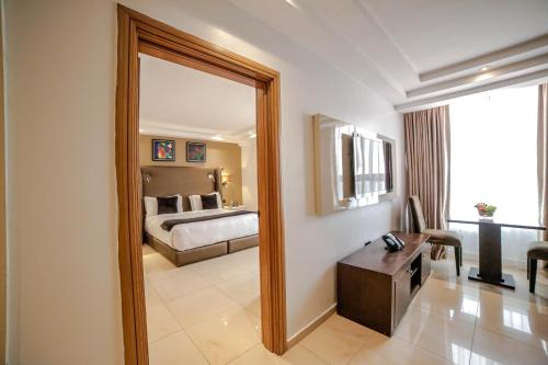 a large mirror in a hotel room with a bed at Victoria Crown Plaza Hotel in Lagos