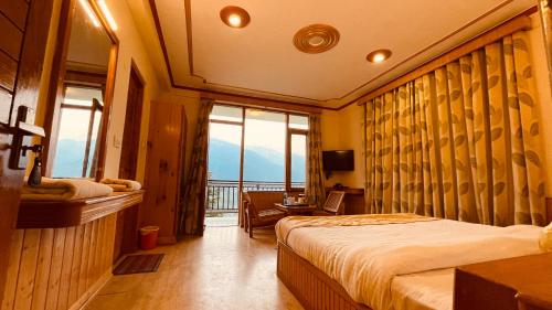 a bedroom with a bed and a window with a view at Himalayan adventure Cottages & Budget Friendly BNB Manali in Manāli