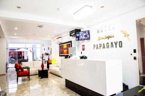 vestíbulo de una farmacia con sofá y mostrador en Hotel Boutique Papagayo, en Tarapoto